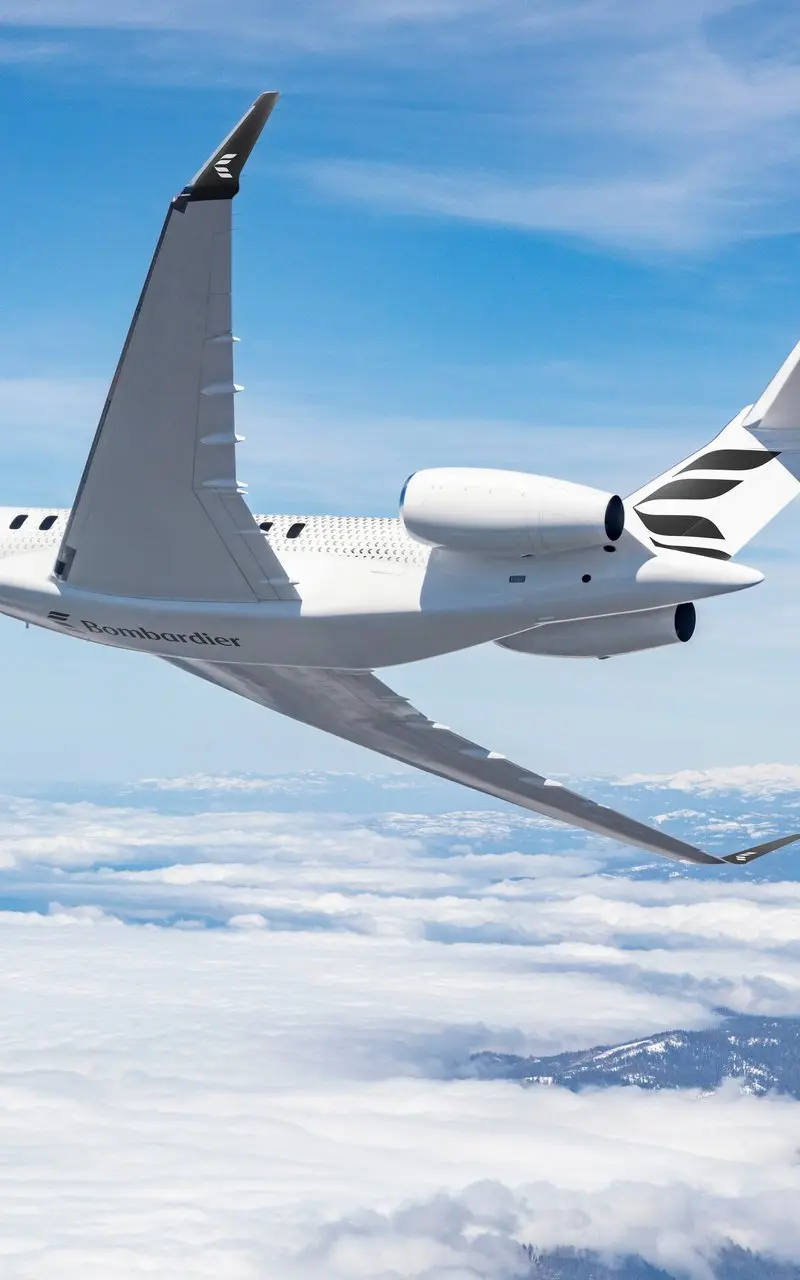 The Bombardier Global 7500 ultra-long-range private jet flies gracefully above clouds with snowy mountains visible below from Madrid.