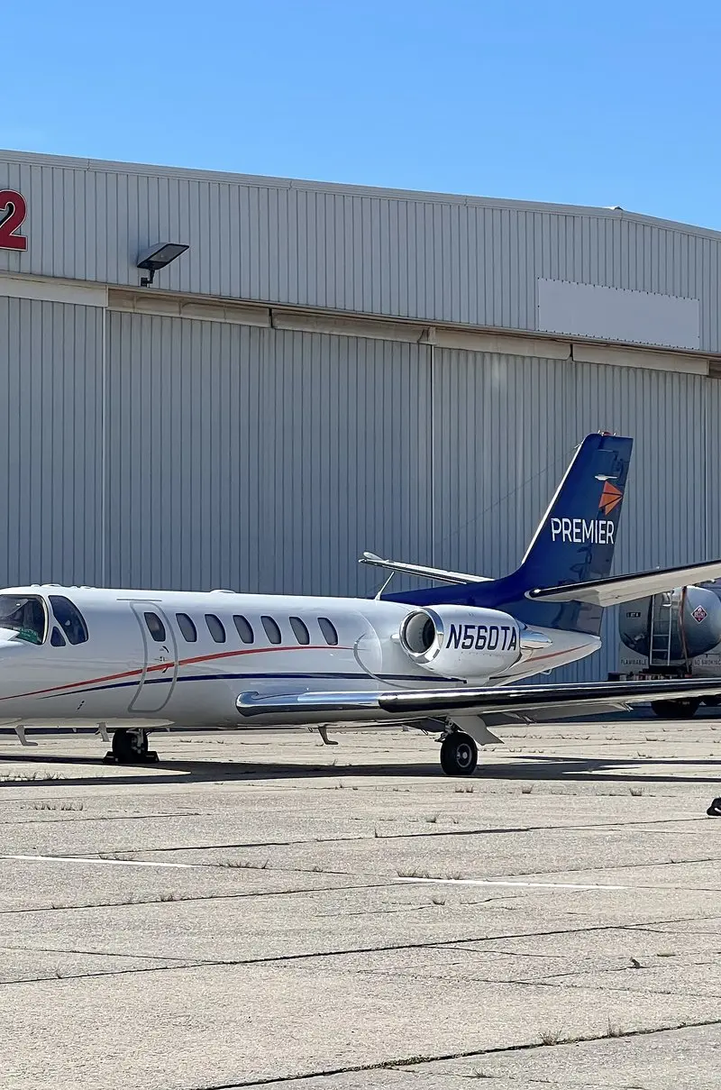 Cessna Citation Ultra — Parked on tarmac, Malaga Cessna Citation Ultra light jet parked on the tarmac in Malaga, with a fuel truck and hangar in the background.