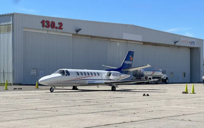 Cessna Citation Ultra — Parked on tarmac, Malaga Cessna Citation Ultra light jet parked on the tarmac in Malaga, with a fuel truck and hangar in the background.