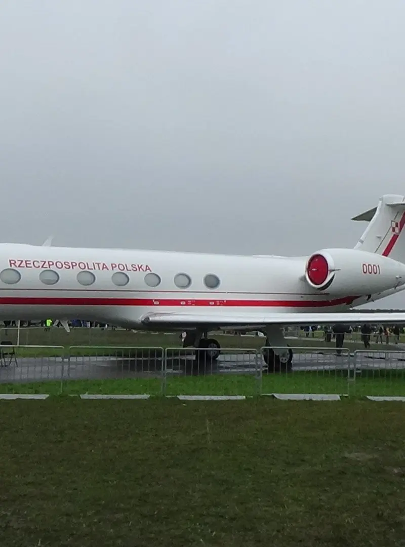 Gulfstream G550 — Ultra-long-range jet exterior A sleek white Gulfstream G550 ultra-long-range private jet is parked on an airfield, showcasing its exterior side profile.