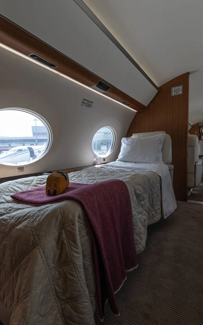 Gulfstream G650 — Luxurious cabin sleeping berth The luxurious Gulfstream G650 cabin features a comfortable sleeping berth and lounge area, with another jet visible outside in Marbella.