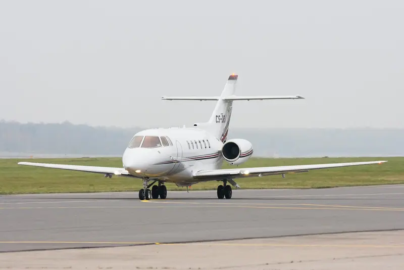 Hawker 800XP — Ready for departure in Barcelona The Hawker 800XP private jet is seen from a front-three-quarter view on the tarmac at Barcelona airport, ready for departure.