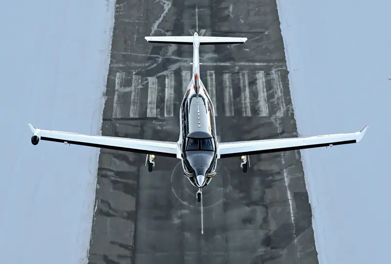 Pilatus PC-12 — Front view on runway The Pilatus PC-12 turboprop is seen from a front-on, elevated view, on a runway in Malaga, ready for flight.